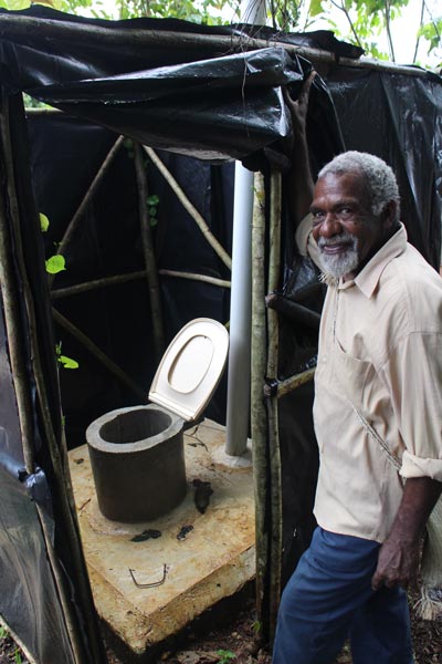 A community chief with a new latrine ©ACOM-V