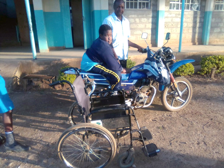 Carren with her father, Geoffrey, riding to school ©Diocese of Eldoret