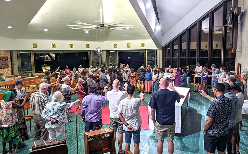 Members of the 2021 Diocese of the NT Synod praying for WALK (a COVID-safe way to lay our hands on others in prayer!) © Diocese of the Northern Territory.