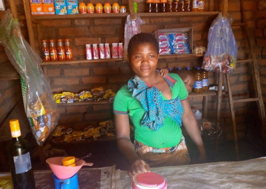 Lydia in the shop she purchased through her Savings Group