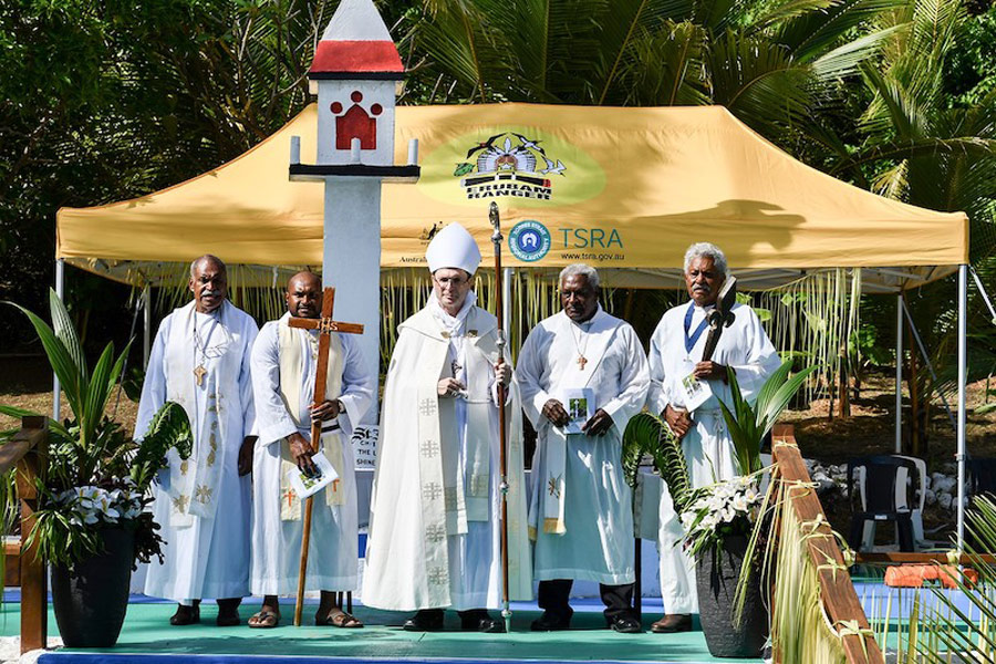 Bishop Keith Joseph (centre) with (from left) Fr Dalton Cowley (Mer), Br Kelliot Betu (Melanesian Brotherhood), Deacon Danny Stephens (Ugar) and Mr Walter Lui (Erub) for the recent celebrations on Erub, standing in front of the Coming of the Light Monument ©Diocese of North Queensland