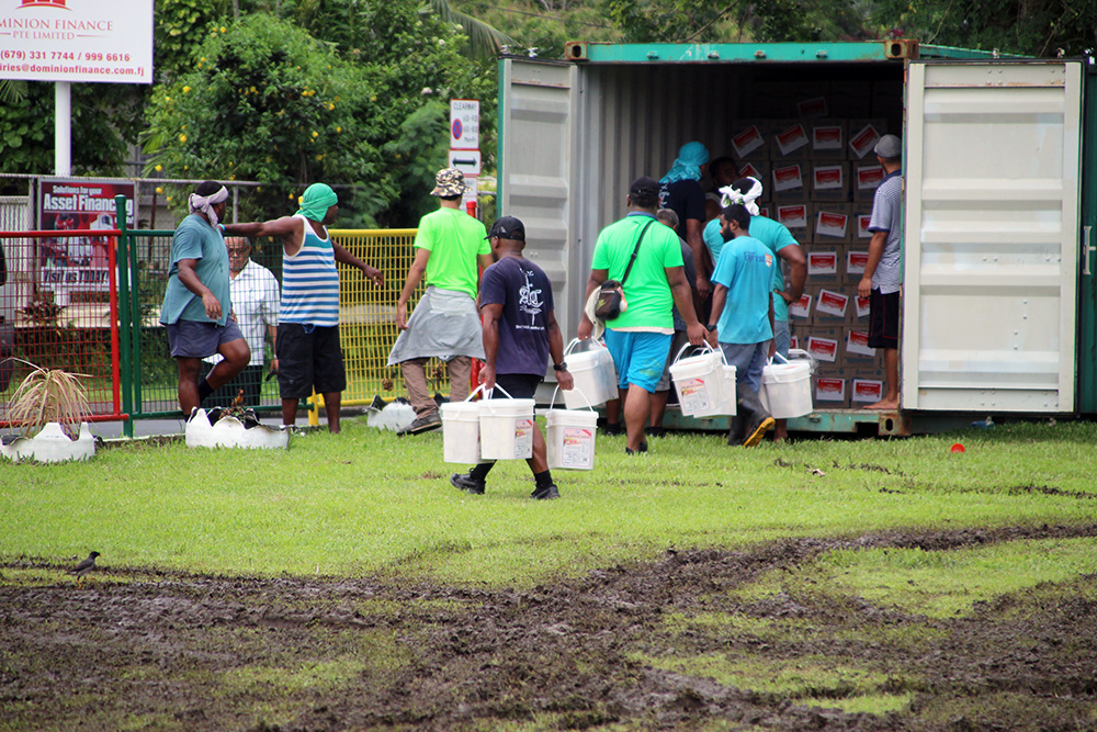 Non-perishable food items are loaded into a container in Suva for shipping to Tonga. © Anglican Missions Board, New Zealand. Used with permission.