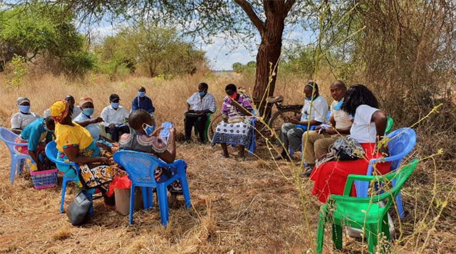 Members of Kiangini Project Management Committee meet under the trees during COVID-19 ©Anglican Development