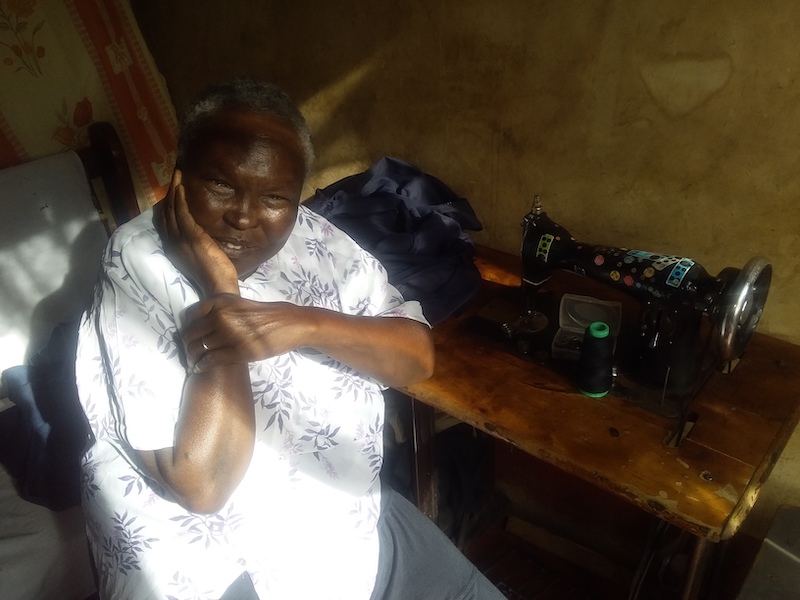 Julie with her old sewing machine before she replaced it with a new one, purchased from her project loan. ©Community-based Rehabilitation Centre, Diocese of Eldoret