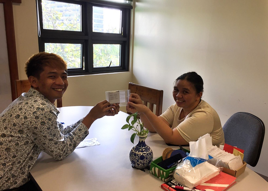 Rosalinda (right) receives her grant from E-CARE. © E-CARE. Used with permission.