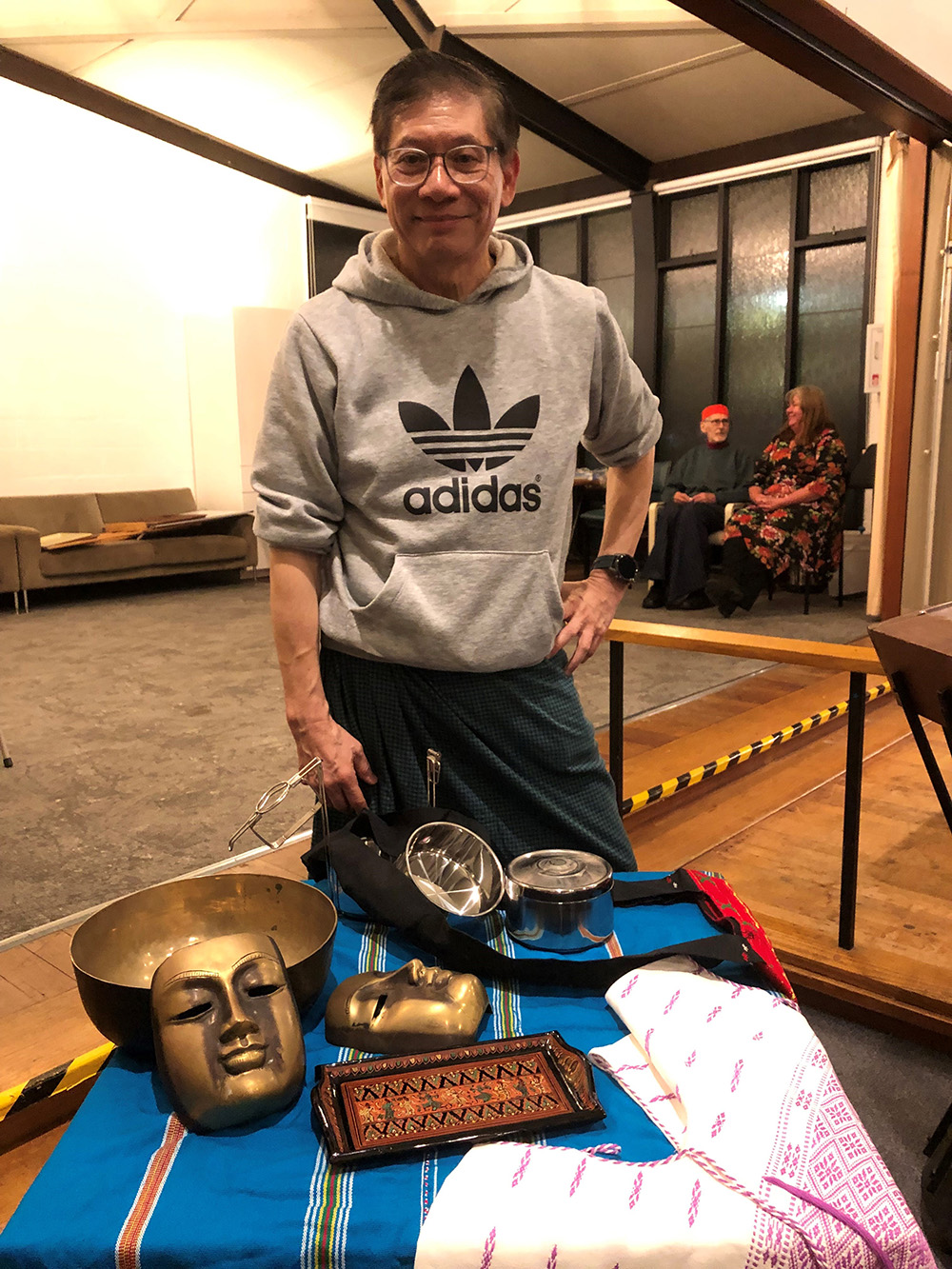 Myanmar pilgrim, Dr Paul Lee, with some Myanmar artefacts at the Holy Cross Hackett event. © ABM.