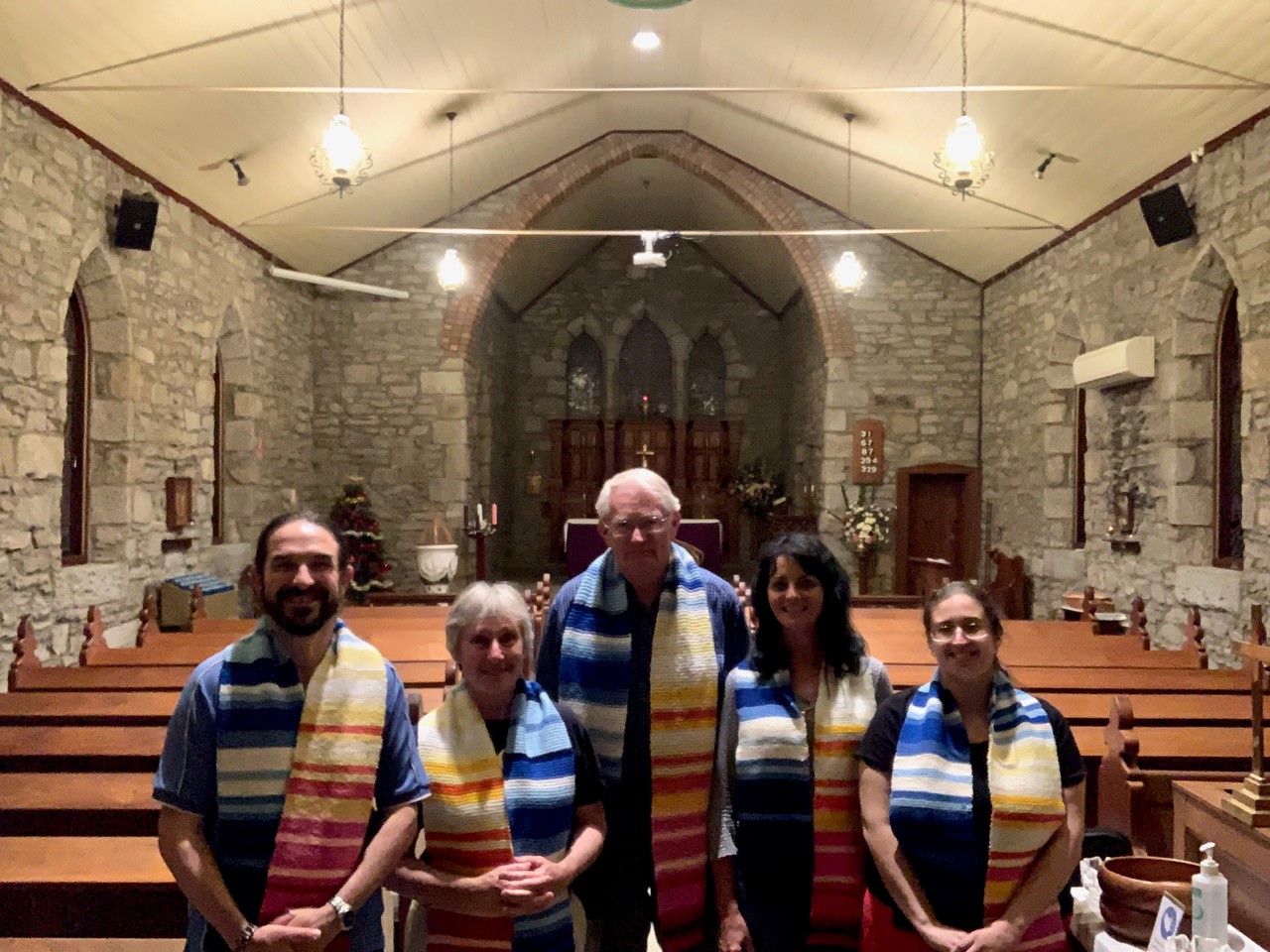 Newcastle Anglican EcoCare members Andrew Eaton, Robyn Fry, Ron Hacker, Di Rayson and Katrina Baldacchino wearing climate change scarves knitted by members of Wallsend parish.