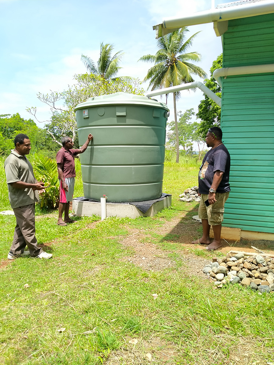 People of Kukaka village with their new water tank. © Anglicare PNG