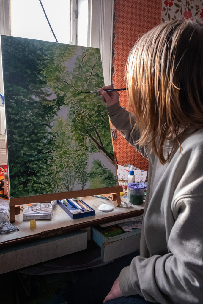 Elizabeth with one of her paintings. © Simon Chambers/ACT Alliance. Used with permission.