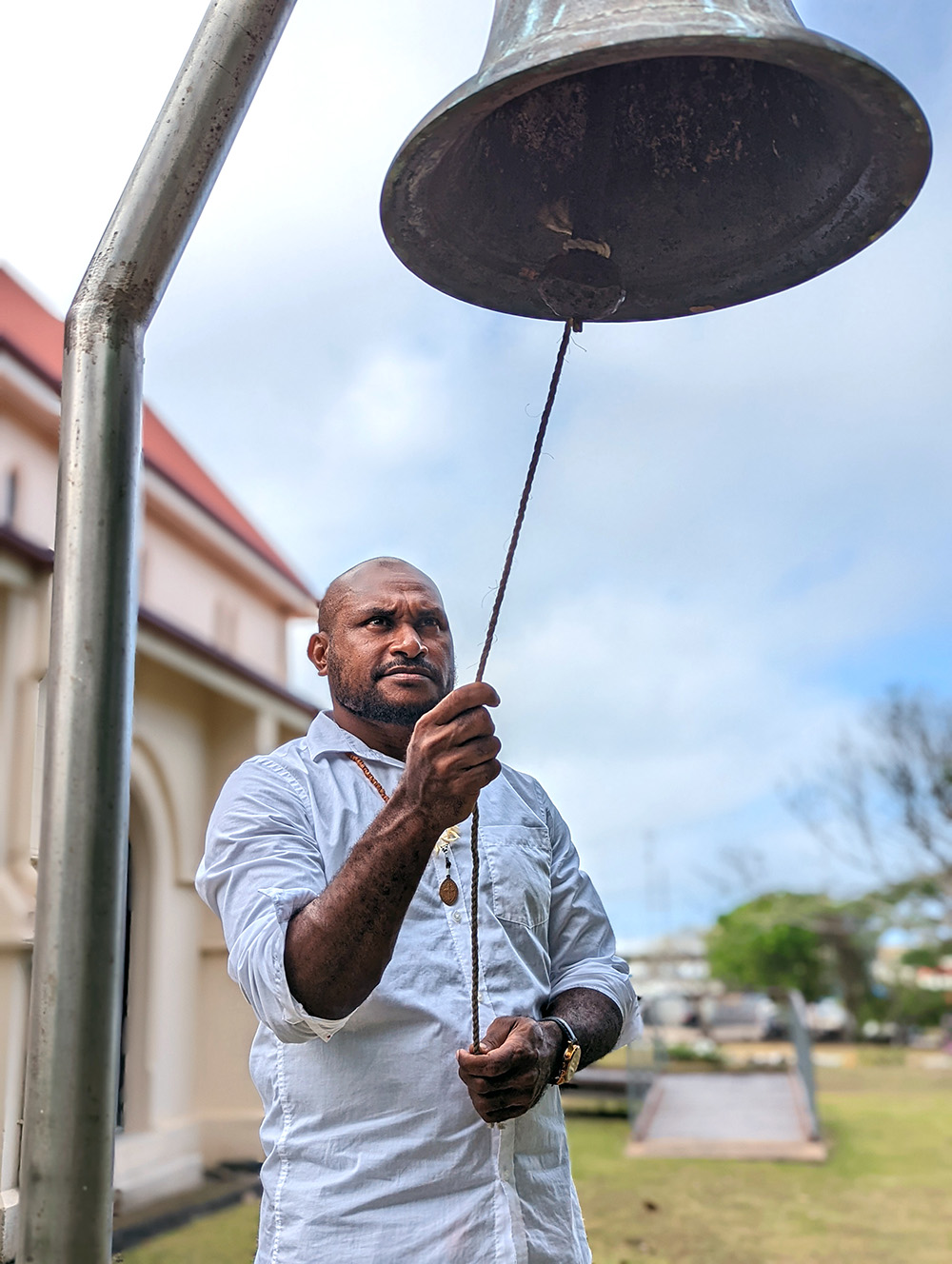 Ringing the bell to celebrate the Coming of the Light at All Souls & St Bartholomew’s Church on Thursday Island. © Brad Chapman, ABM.
