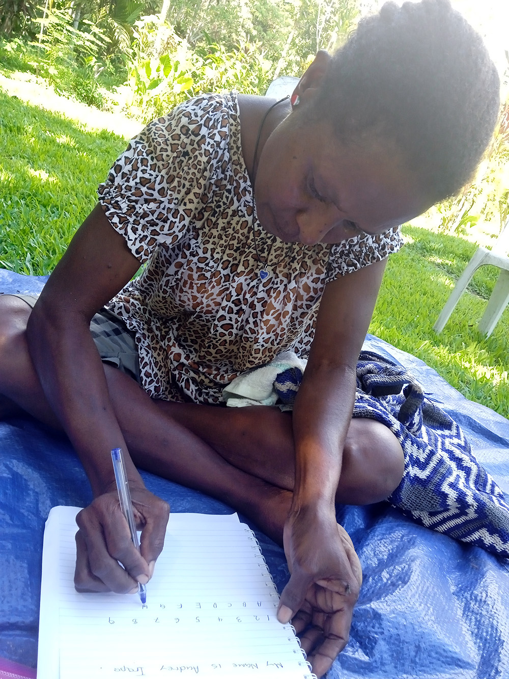 Audrey shows off her literacy and numeracy skills. © Anglicare PNG. Used with permission.
