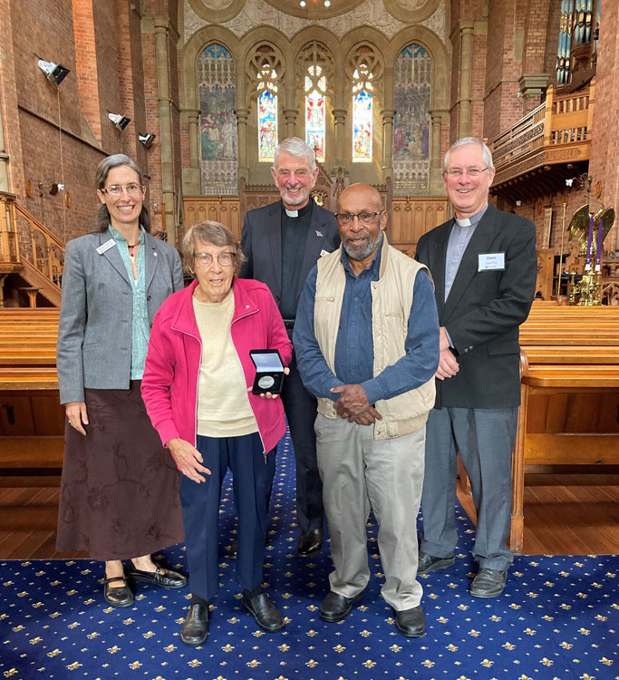 Lesley (front left) is pictured with her Coaldrake Medal. Her husband, Bishop Dennis Ririki (formerly of Aipo Rongo Diocese in Papua New Guinea) is beside her. Meagan Schwarz, the Rev’d Warwick Cuthbertson and the Rev’d Dane Courtney are pictured in the back row ©ABM