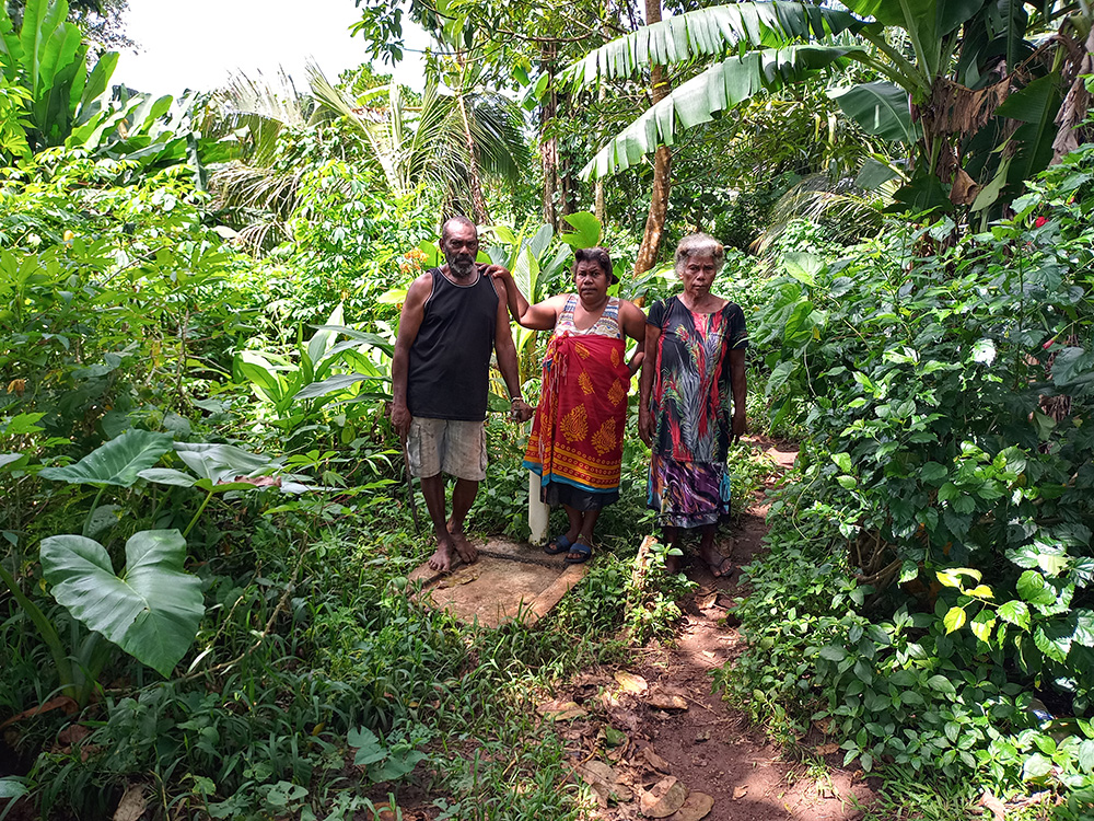 Locals in Fanafo show their stand pipe. © Terry Russell, AID.