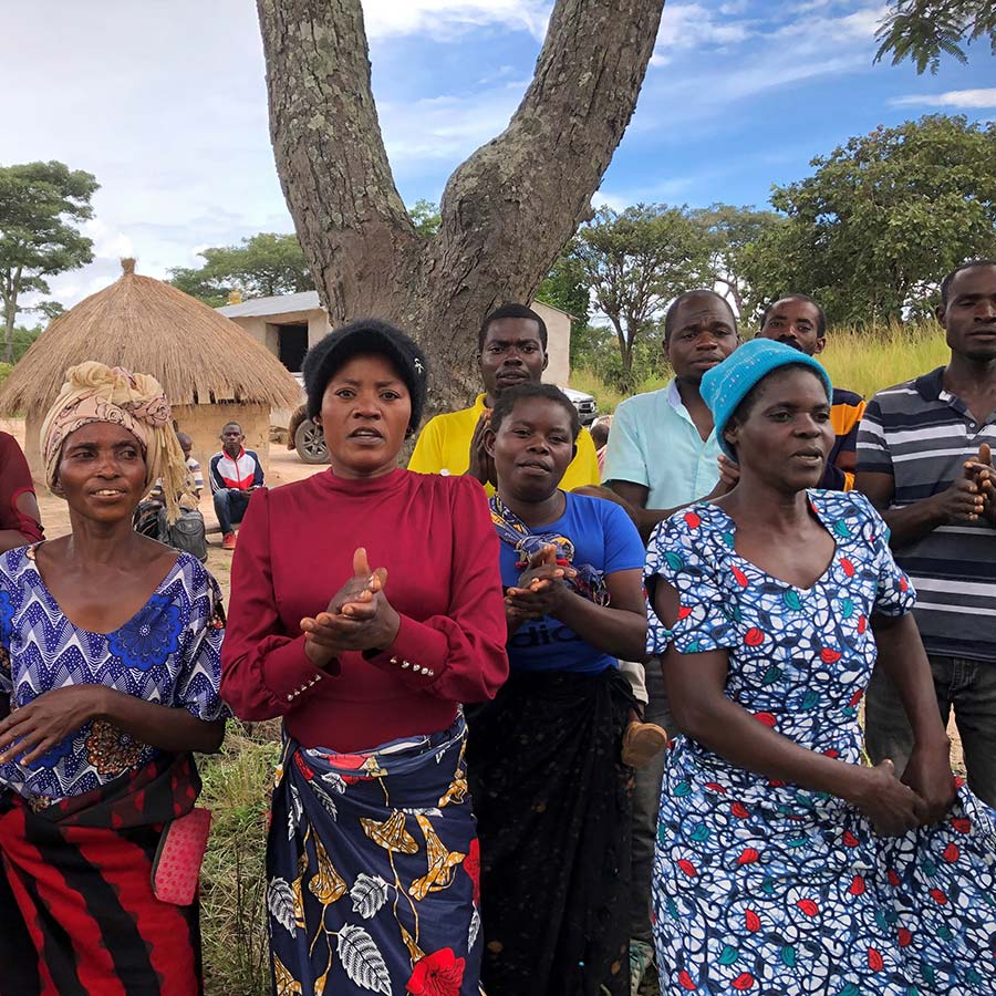 Women welcome visitors to village Koama Makasa March 2023