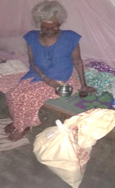 A woman receives a food relief pack. © Diocese of Colombo. Used with permission.