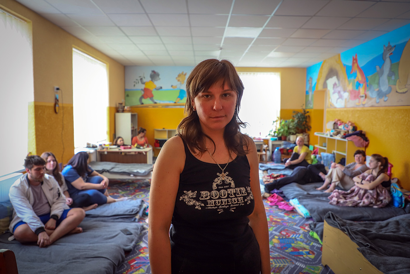 Irina, 31, now lives with 12 other people in this room in western Ukraine. © HIA. Used with permission.