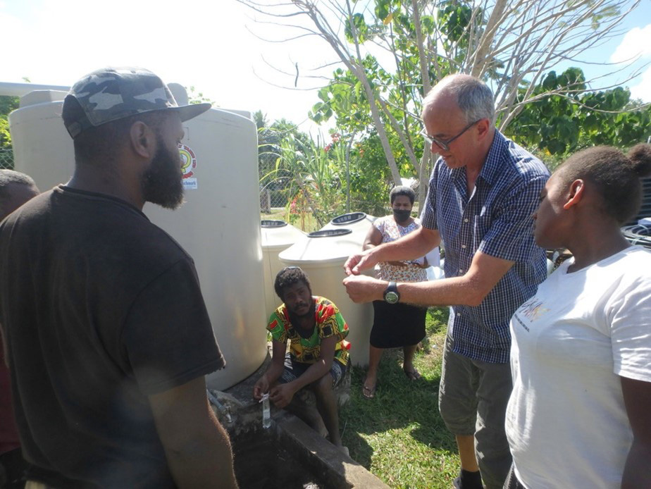 Peter discusses water pressure and quality with ACOM staff and volunteers. © ACOM Vanuatu. Used with permission.
