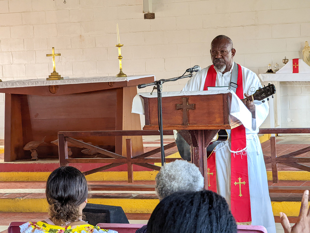 Reverend Ned Wapua is a senior Torres Strait Islander Anglican Priest and an accomplished guitarist. He is pictured here leading worship on Moa Island, Torres Strait. © ABM/Brad Chapman, 2022.