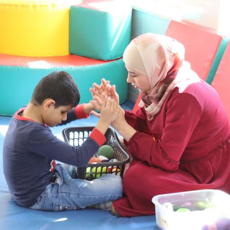 A teacher works one-on-one with a student at the Holy Land Institute for the Deaf. © HLID. Used with permission.