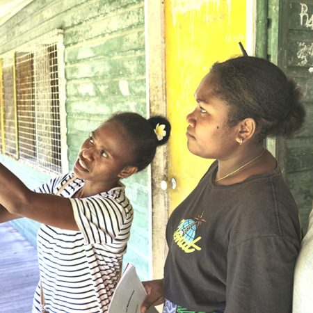 ACOM’s Freda Fataka (left) showing secondary students Margreth and Christalyn how to take temperature readings. Margreth (centre) says her favourite subject is science. “I have learned how to record scientific data,” she says. “Documenting this helps me understand about climate change. I feel sad that the shoreline is washing away.” © ABM/ Isabel Robinson.