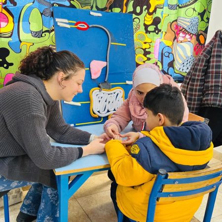 Tactile sign language is taught at the school. As a Deafblind person cannot see signs, the hands of both people touch so the deafblind person can feel what the other person wants to say. © HILD. Used with permission.