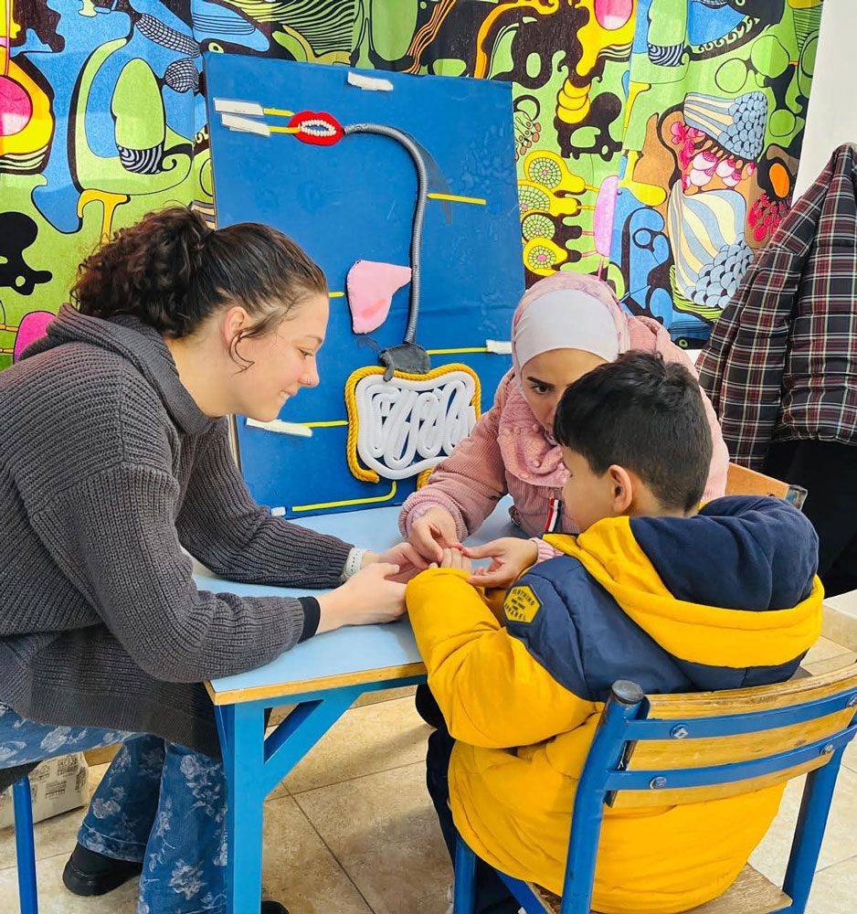Tactile sign language is taught at the school. As a Deafblind person cannot see signs, the hands of both people touch so the deafblind person can feel what the other person wants to say. © HILD. Used with permission.