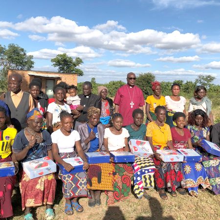 Savings with Education group leaders receiving their group’s cash box © Julianne Stewart/ABM