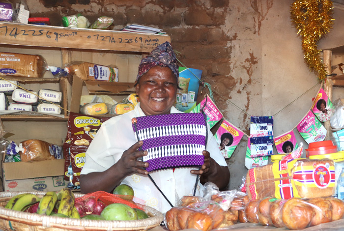 Jacinta Mutua at her shop showcasing the baskets. © ADSE. Used with permission.