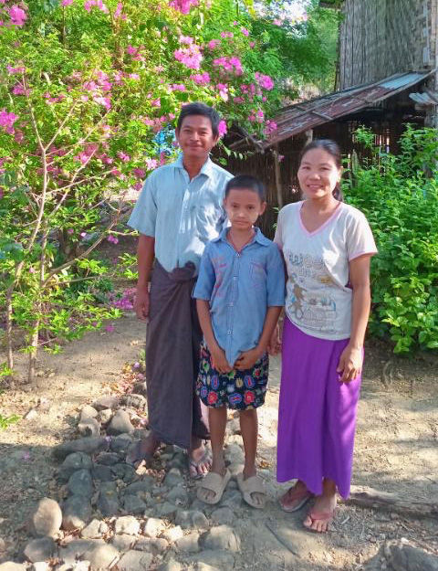 Win, his wife Naing, and their son in 2025. Win’s son is now thriving at school.