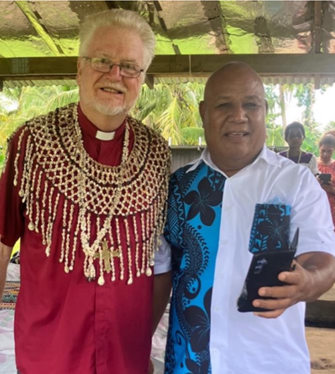 Bishop Jeffrey with Oro Province Education Advisor, Mr Maino Vegoli. Bishop Jeffrey was presented with an elaborate shell necklace, a symbol of esteem in Melanesian culture.