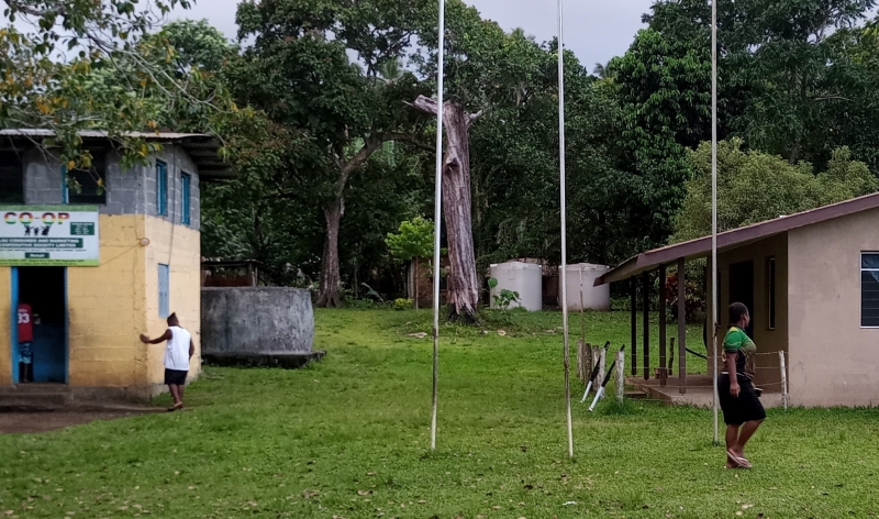 Two water tanks set on the hillside behind the village healthcare post and co-op building. © Terry Russell, ABM AID