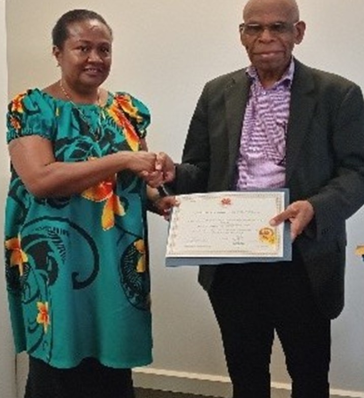 Acting Secretary for Department of Higher Education, Research, Science and Technology, Mr Lonnie Baki, is shown presenting the Modawa Institute’s Certificate of Registration to Mrs Elizabeth Bokai, Executive Assistant to the Principal.