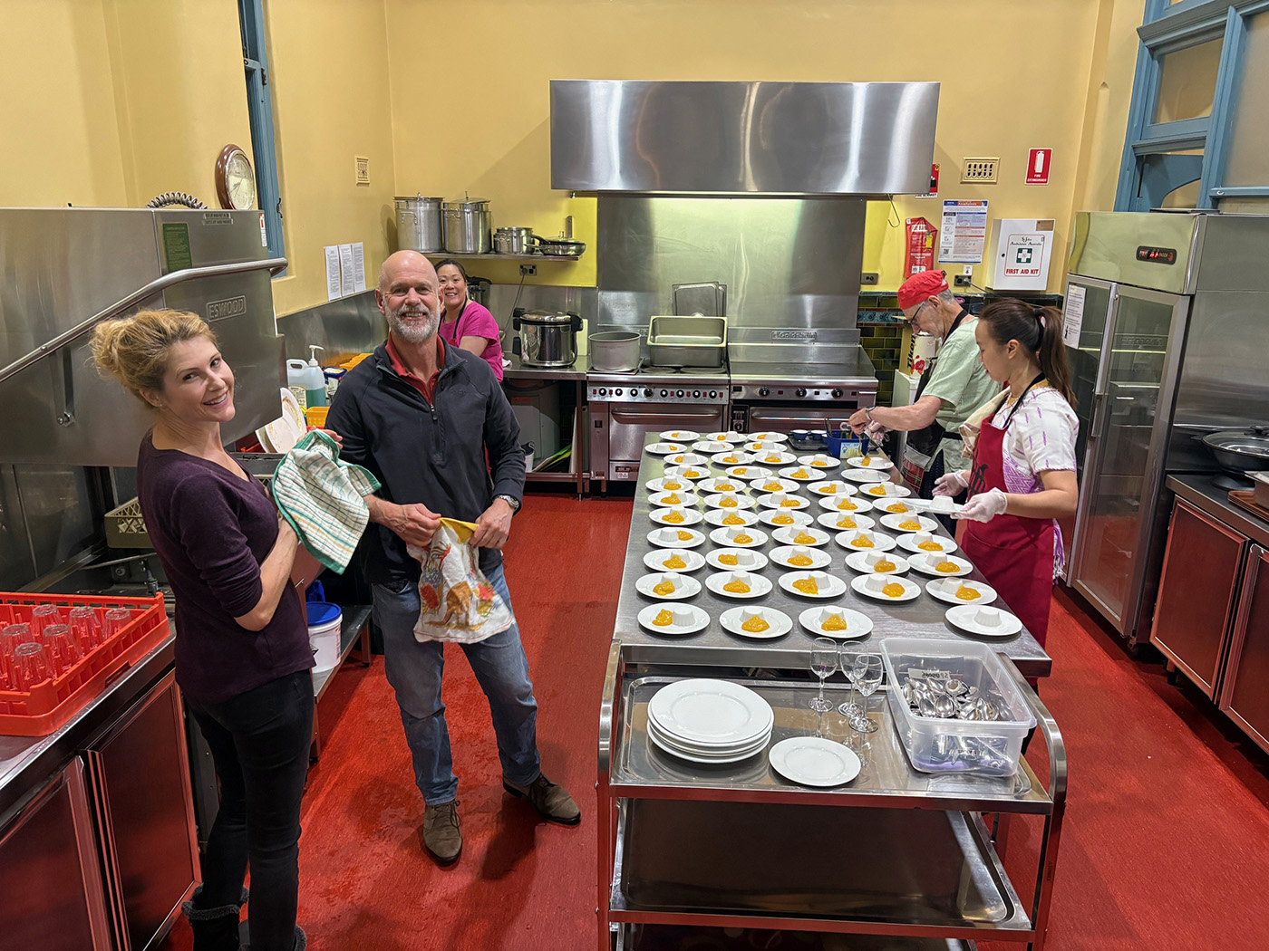Myanmar Roadshow team members hard at work in the kitchen led by Colin Bannerman (in the red hat).