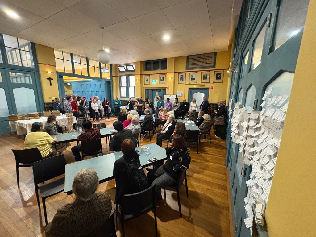 Supporter Gathering participants hear Isabel Robinson’s ABM story. The timeline showing everyone’s contribution to the ABM story is on the far right. © ABM