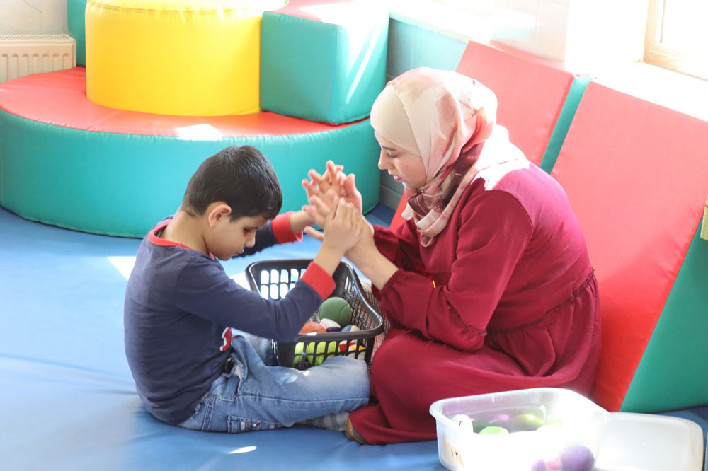 A teacher works one-on-one with a student at the Holy Land Institute for the Deaf. © HLID. Used with permission.