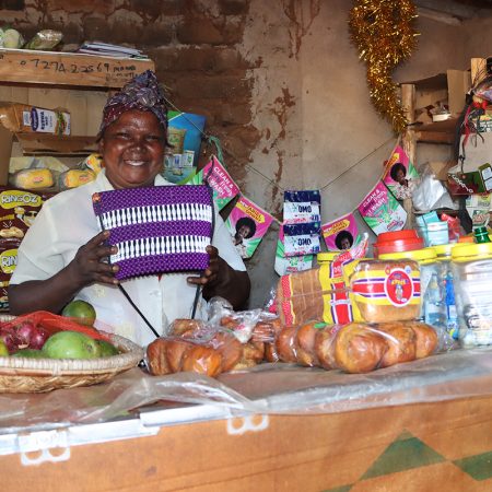 Jacinta Mutua at her shop showcasing the baskets. © ADSE. Used with permission.