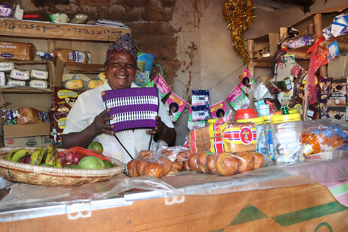Jacinta Mutua at her shop showcasing the baskets. © ADSE. Used with permission.