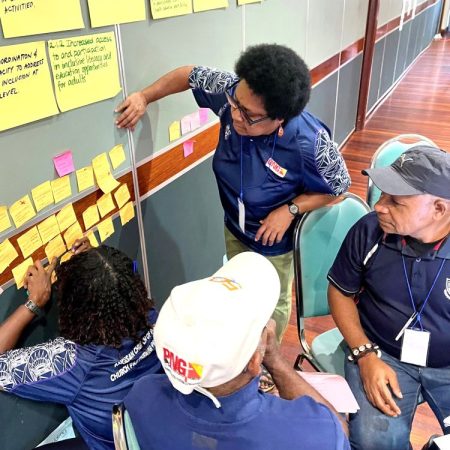 It's all in the planning: staff from the Anglican Church of Papua New Guinea's CPP program plan activities for the year ahead © Kate Winney, ABM AID. Used with permission.